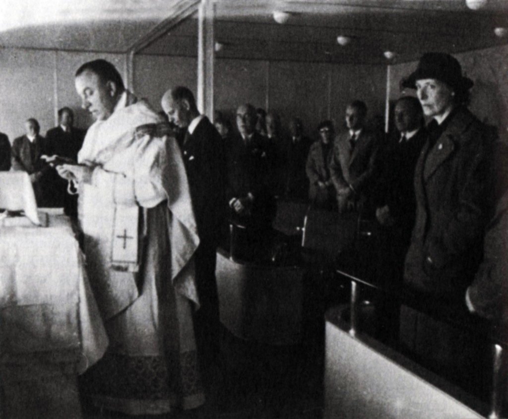 Father Paul Schulte leading the world's first aerial mass.  ("First Flighter" Clara Adams at right.)