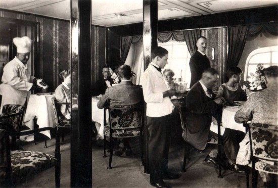 Heinrich Kubis (standing, dark jacket) in Dining Room of LZ-127 Graf Zeppelin